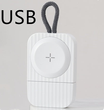 A compact USB wireless charger in use, charging a phone while connected to a laptop via USB.