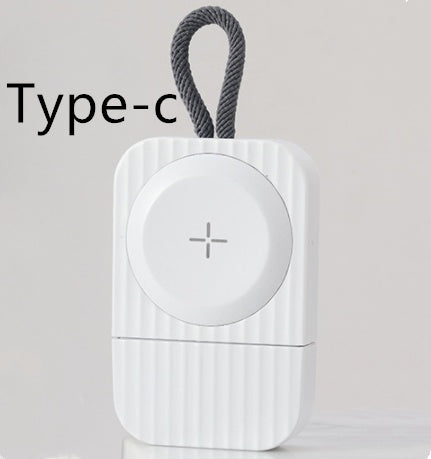 A USB wireless charger with a green LED light indicating a device is charging on a wooden table.
