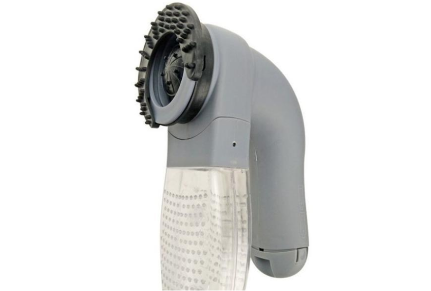 Pet hair remover next to a cat, showing its effectiveness.